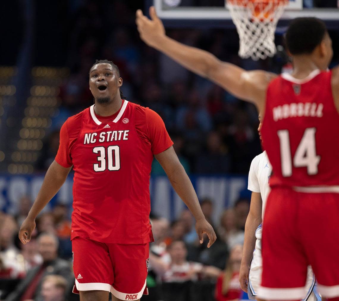 N.C State’s D.J. Burns Jr. (30) and Casey Morsell (14) react after the Wolfpack opened a ten point lead over North Carolina in the second half during the ACC Men’s Basketball Tournament Championship at Capitol One Arena on Saturday, March 16, 2024 in Washington, D.C. 
