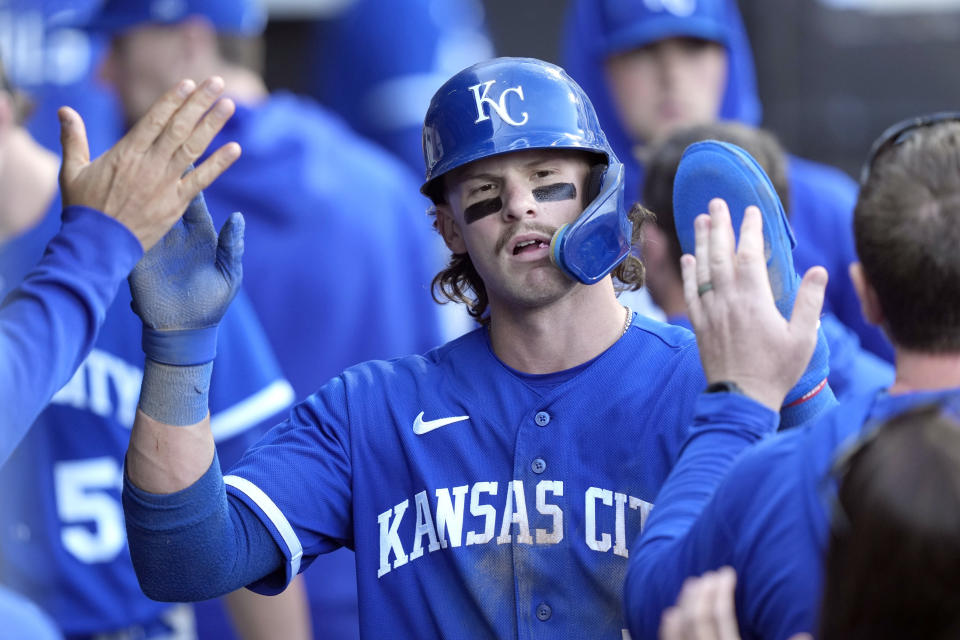 Kansas City Royals' Bobby Witt Jr. is greeted in the dugout after scoring on Edward Olivares' RBI double off Chicago White Sox starting pitcher Dylan Cease during the fourth inning in the first baseball game of a doubleheader, Tuesday, Sept. 12, 2023, in Chicago. (AP Photo/Charles Rex Arbogast)