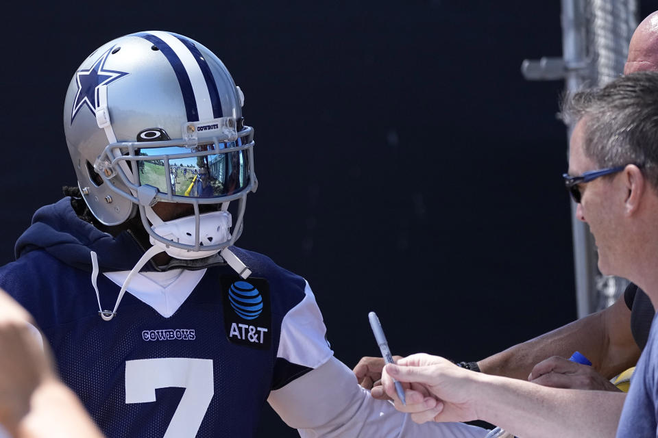 Dallas Cowboys cornerback Trevon Diggs signs an autograph during the NFL football team's training camp Thursday, July 27, 2023, in Oxnard, Calif. (AP Photo/Mark J. Terrill)