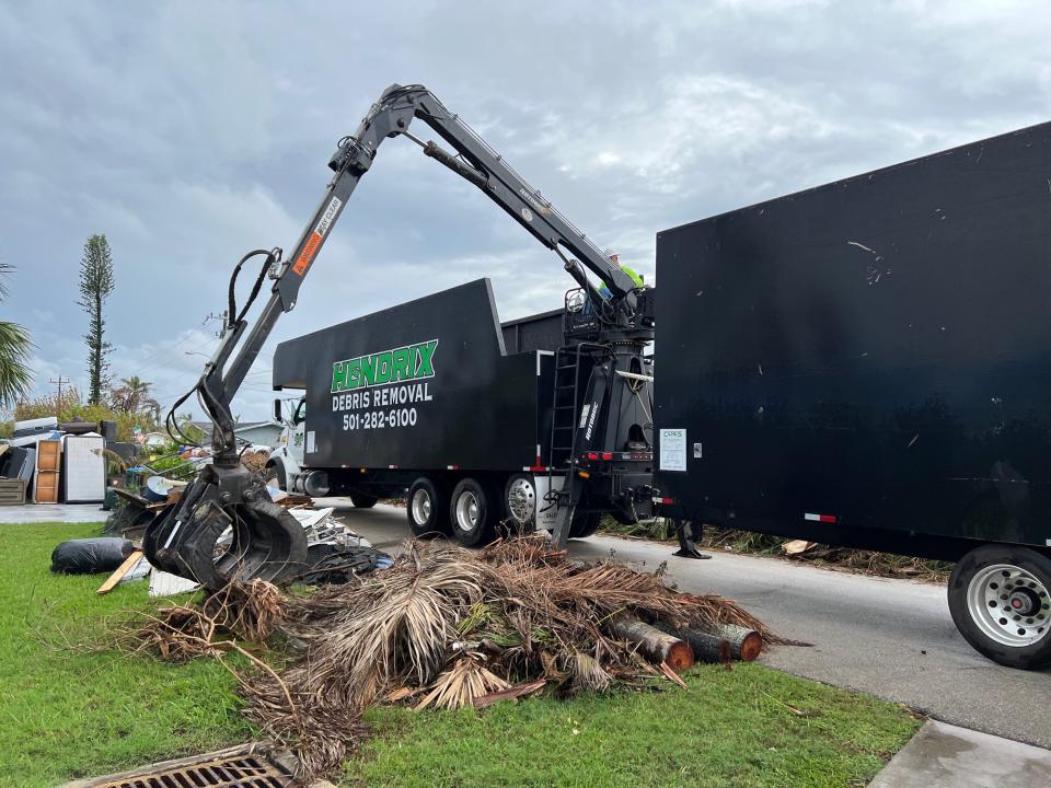 Contractor Hendrix picks up debris in a neighborhood in southeast Cape Coral to pick up storm debris.