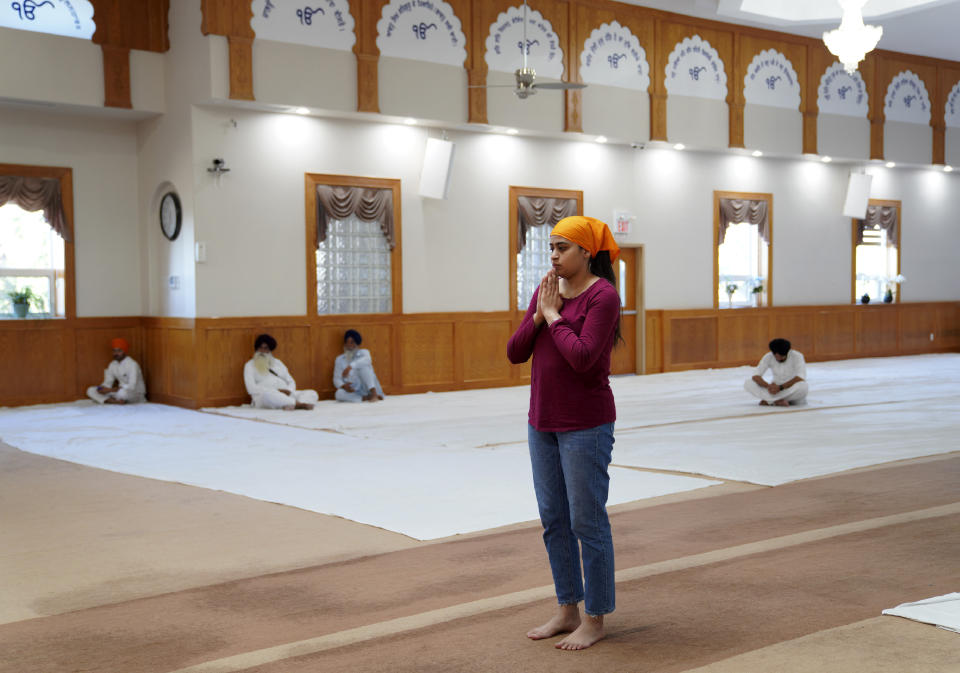 Worshippers attend evening prayer at Gurdwara Millwoods, a Sikh house of worship, in Edmonton, Alberta, on Wednesday, July 20, 2022. (AP Photo/Jessie Wardarski)