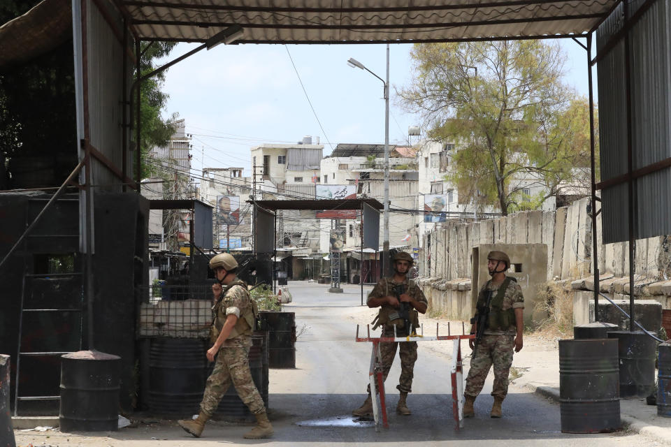 Lebanese soldiers take stand guard on a check point during a third day of clashes that erupted between members of Palestinian President Mahmoud Abbas' Fatah group and Islamist factions in the Palestinian refugee camp of Ein el-Hilweh near the southern port city of Sidon, Lebanon, Monday, July 31, 2023. (AP Photo/Mohammad Zaatari)