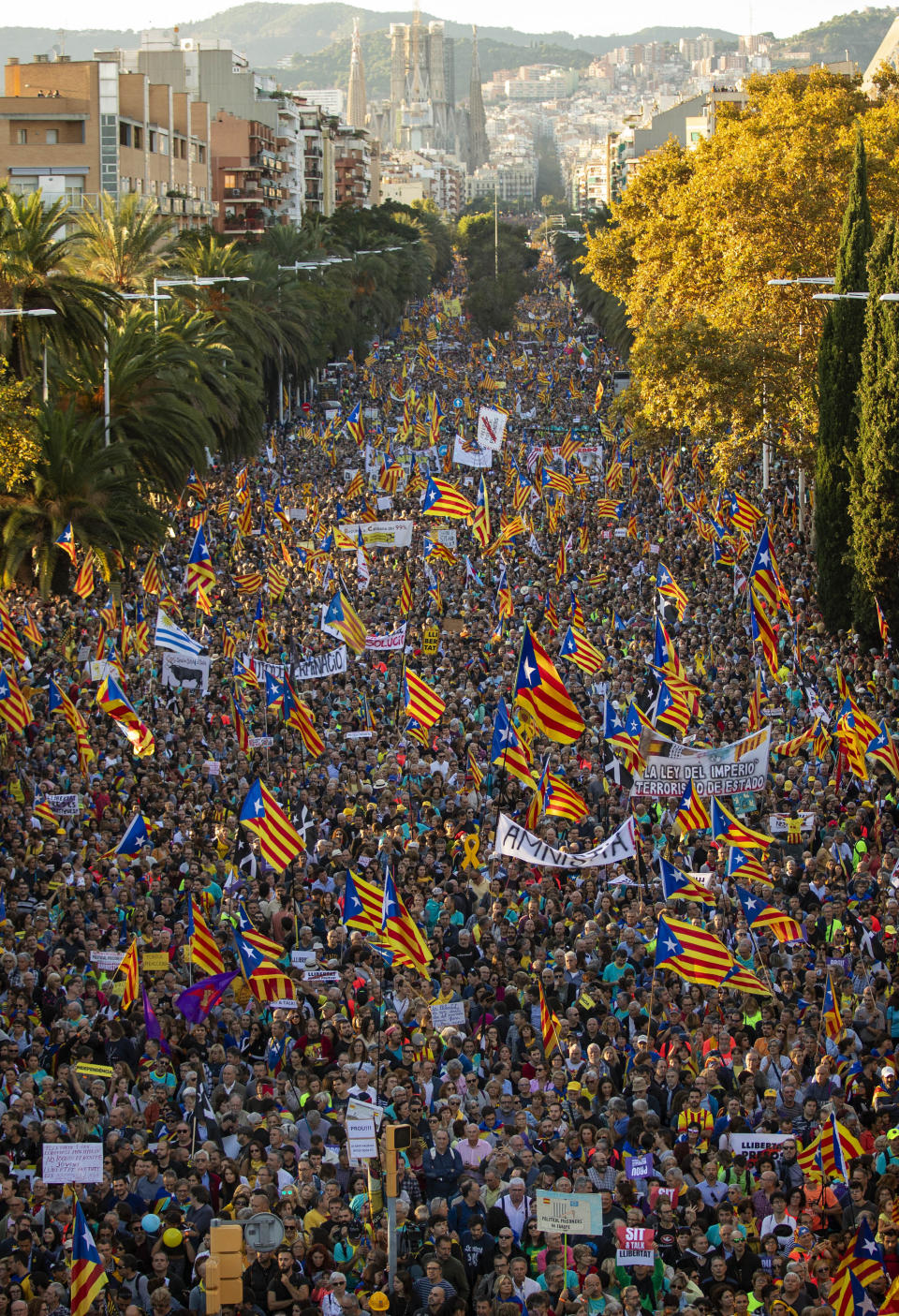 Catalan pro-independence protesters gather during a demonstration in Barcelona, Spain, Saturday, Oct. 26, 2019. Protests turned violent last week after Spain's Supreme Court convicted 12 separatist leaders of illegally promoting the wealthy Catalonia region's independence and sentenced nine of them to prison. (AP Photo/Emilio Morenatti)