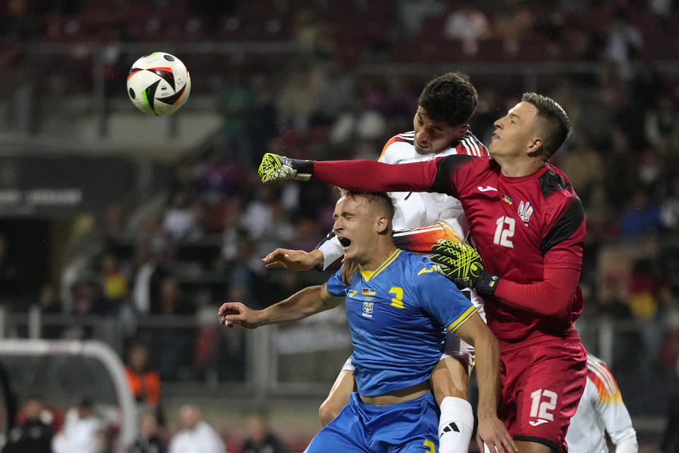 FILE - Ukraine's goalkeeper Anatoliy Trubin punches the ball away under pressure from Germany's Kai Havertz during an international friendly soccer match between Germany and Ukraine in Nuremberg, Germany, Monday, June 3, 2024. The unpredictability of the European Championship, which kicks off in Munich on Friday, is what makes it such compelling viewing. Even in its expanded format of 24 teams, there is always the potential for a surprise. (AP Photo/Matthias Schrader, File)