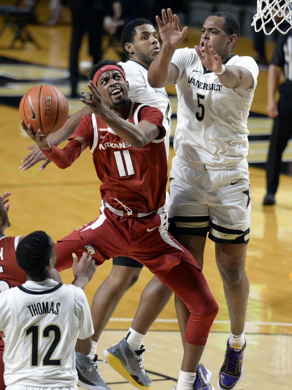 Arkansas guard Jalen Tate (11) shoots against Vanderbilt guard D.J. Harvey (5) during the second half of an NCAA college basketball game against Vanderbilt Saturday, Jan. 23, 2021, in Nashville, Tenn. Arkansas won 92-71. (AP Photo/Mark Zaleski)