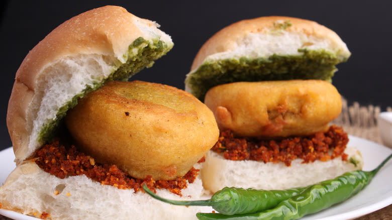 Two vada pavs on a plate