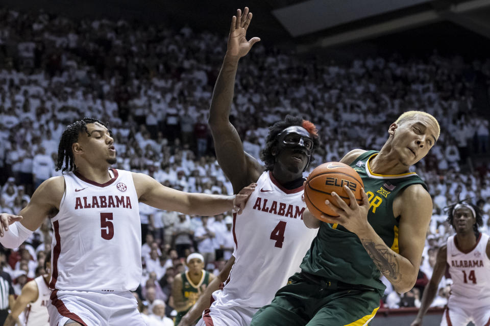 Baylor forward Jeremy Sochan (1) rebounds the ball in front of Alabama guard Jaden Shackelford (5) and forward Juwan Gary (4) during the first half of an NCAA college basketball game, Saturday, Jan. 29, 2022, in Tuscaloosa, Ala. (AP Photo/Vasha Hunt)