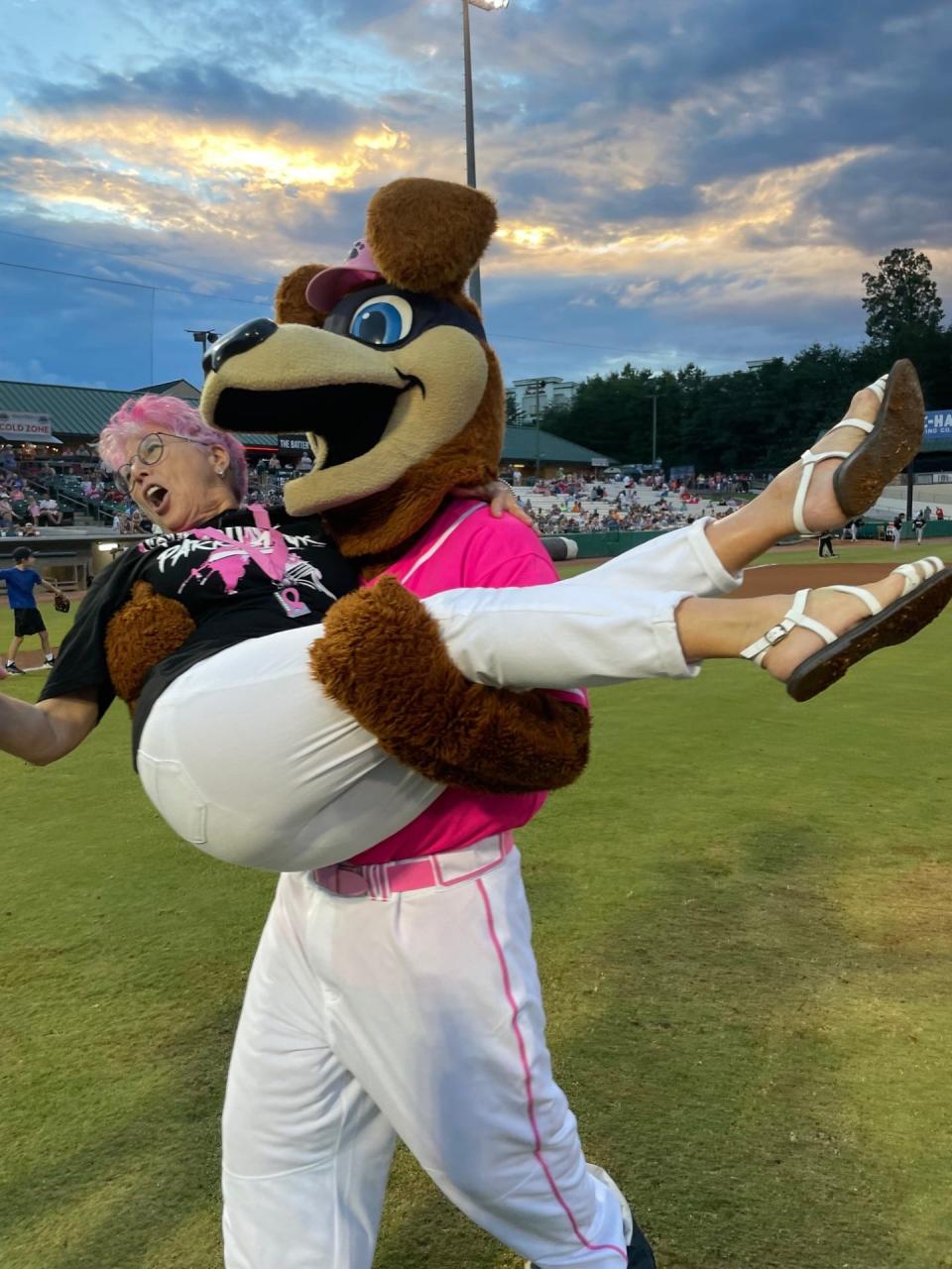 After her ceremonial first pitch at the “Paint the Park Pink” celebration at Smokies Stadium, Mary Ann Venable was carried off the field by Tennessee Smokies mascot Homer Hound.