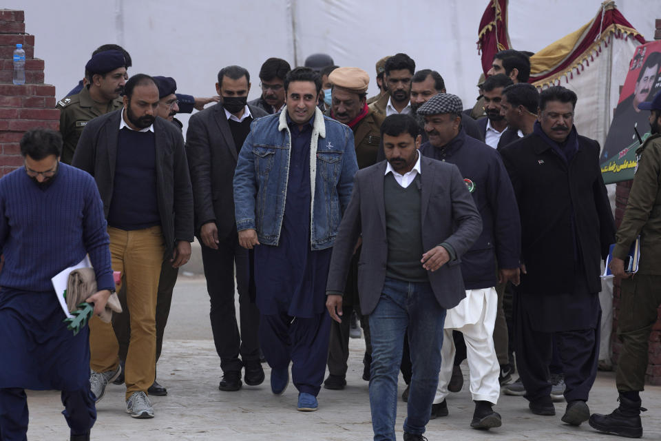 Bilawal Bhutto Zardari, center, Chairman of Pakistan People's Party is escorted by security personnel and party's aid as he arrives to address supporters at an election campaign rally, in Bhalwal, Pakistan, Wednesday, Jan. 24,2024. (AP Photo/Anjum Naveed)