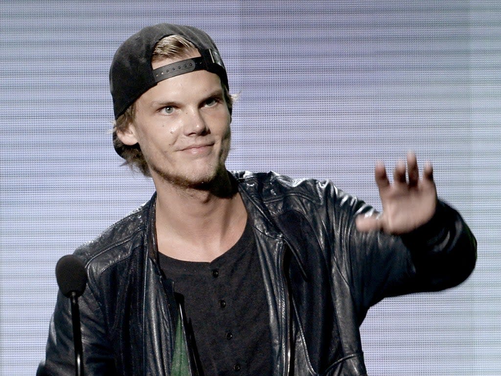 Avicii accepts the Favorite Electronic Dance Music Artist trophy at the American Music Awards on 24 November 2013 in Los Angeles, California (Kevin Winter/Getty Images)