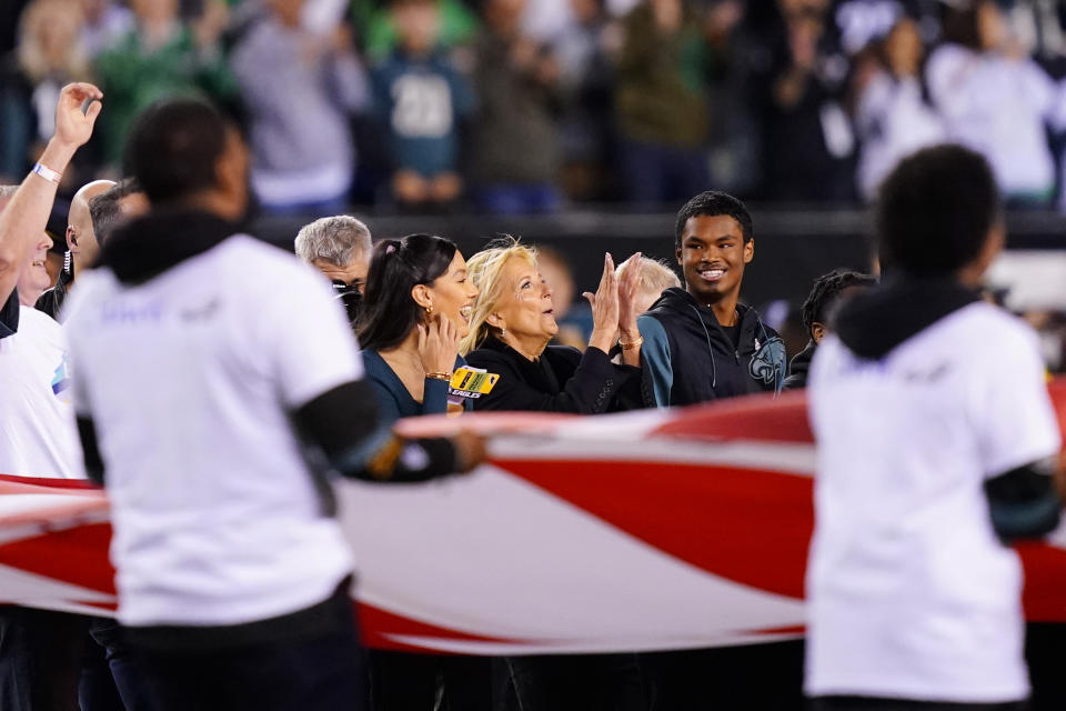 FILE - First lady Jill Biden, center, stands on the field before an NFL football game between the Philadelphia Eagles and Dallas Cowboys on Oct. 16, 2022, in Philadelphia. (AP Photo/Matt Rourke, File)