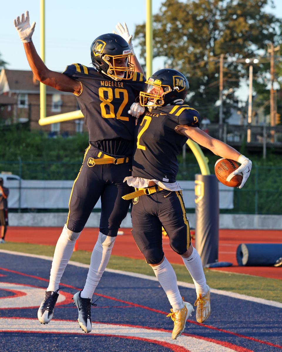 Moeller wide receiver Ryan Mechley celebrates his touchdown catch with teammate Jacob Gearhart in the game between Louisville (Ky.) Trinity and Moeller high schools at Norwood High School Shea Stadium Aug. 26, 2022.