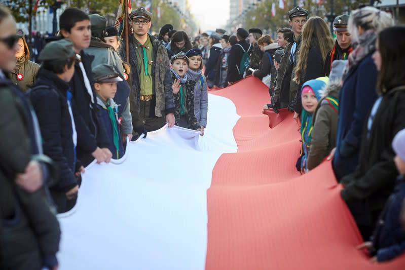 People take part in a parade marking the National Independence Day in Lodz