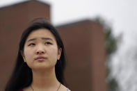 High school student Grace Hu, 16, of Sharon, Mass., stands for a photograph near Sharon High School, Sunday, April 11, 2021, in Sharon. Hu, who plans to to go back to in-person classes in April, helped organize a rally in Boston in early April against anti-Asian hate, but said she's not concerned about facing vitriol when her school reopens fully. The district, located about 27 miles south of Boston, has a sizable Asian student population and has felt generally safe and welcoming to her. (AP Photo/Steven Senne)