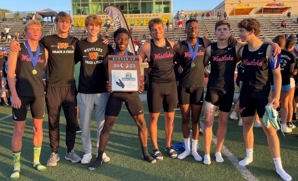 Members of the Westlake High boys track team pose with the CIF-SS Division 2 team runner-up plaque after finishing second on Saturday at Moorpark High.