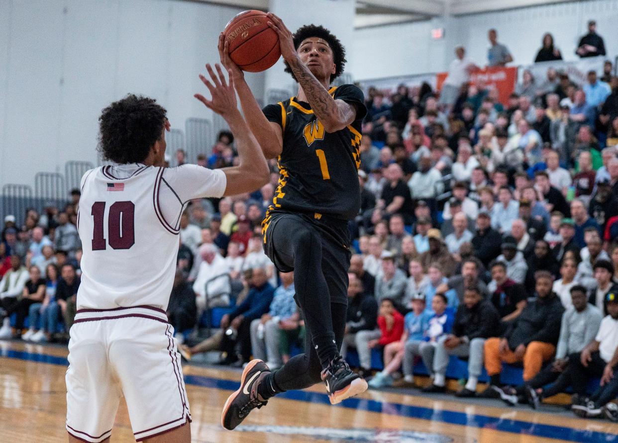 Archbishop Wood's Jalil Bethea (1) drives in for a layup against Lower Merion's Justin Mebane (10) during the PIAA Class 6A state playoffs.