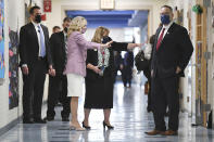 First lady Jill Biden waves to students in a classroom as she tours Benjamin Franklin Elementary School with Education Secretary Miguel Cardona, right, Wednesday, March 3, 2021 in Meriden, Ct. (Mandel Ngan/Pool via AP)