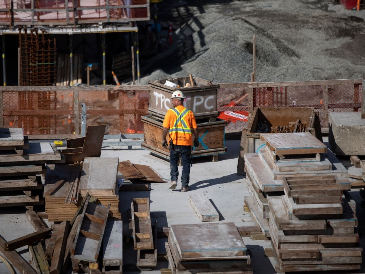 Construction crews are pictured at a development site in New Westminster, B.C., on June 17, 2022.  (Ben Nelms/CBC - image credit)