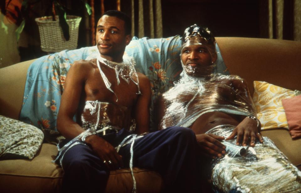 Jamie Foxx wrapped in kitchen plastic wrap on the couch