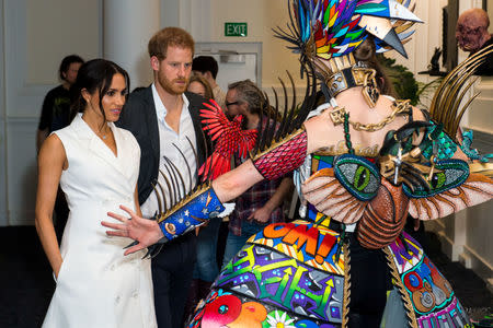 Britain's Prince Harry and Meghan, Duchess of Sussex, meet actors in costumes during a visit to Courtenay Creative, in Wellington, New Zealand October 29, 2018. Dominic Lipinski/Pool via REUTERS