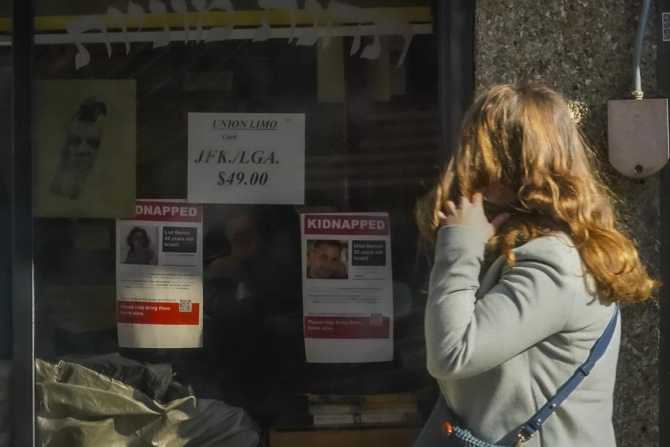 Posters of people being held hostage by Hamas after its attack on Israel last month is posted on the window of a store in the Crown Heights area of Brooklyn, Friday, Nov. 3, 2023, in New York. While the posters were created to raise awareness and support they've also angered others who are critical of Israel's actions and history in the conflict with Palestinians. (AP Photo/Bebeto Matthews)