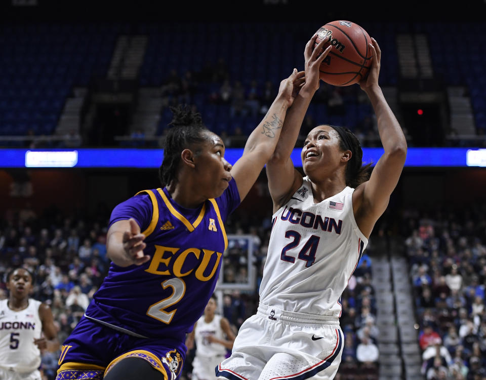 Connecticut's Napheesa Collier, right, is fouled by East Carolina's c during the first half of an NCAA college basketball game in the American Athletic Conference tournament quarterfinals, Saturday, March 9, 2019, at Mohegan Sun Arena in Uncasville, Conn. (AP Photo/Jessica Hill)