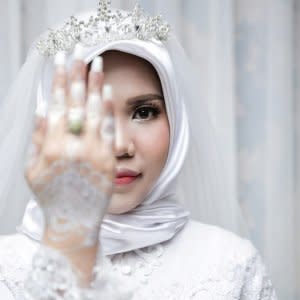 A wedding photo of the bride of a Lion Air flight JT610 victim, who carried on the celebration despite the absence of the groom, in Bangka, Bangka Belitong Province, Indonesia November 11, 2018 in this picture obtained from social media on November 16, 2018. LALA INDRA PERMANA/via REUTERS