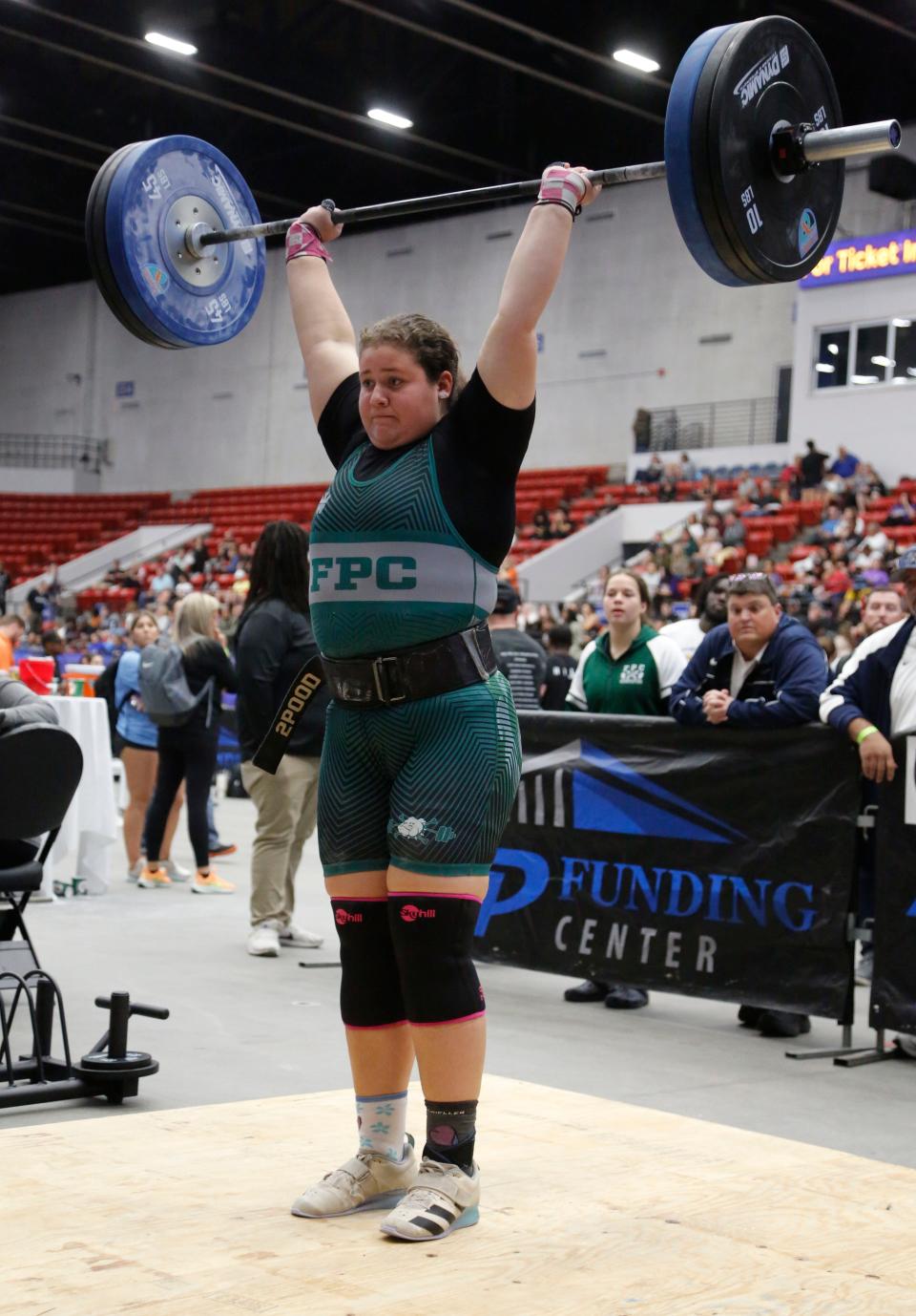 Flagler Palm Coast's Zoey Gotera, who finished third in the unlimited Olympic event, completes a 190-pound clean and jerk during the FHSAA girls weightlifting championships.