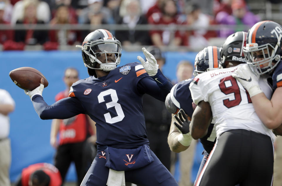 Virginia's Bryce Perkins (3) looks to pass against South Carolina during the first half of the Belk Bowl NCAA college football game in Charlotte, N.C., Saturday, Dec. 29, 2018. (AP Photo/Chuck Burton)