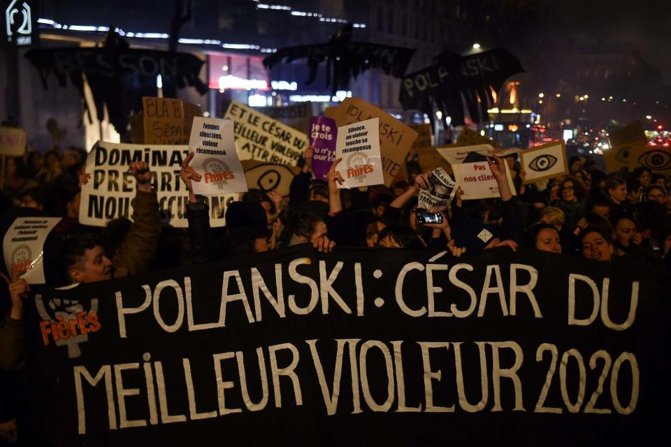 Feminist activists hold a banner reading 'Polanski: Cesar 2020 award for best rapist' (AFP via Getty Images)