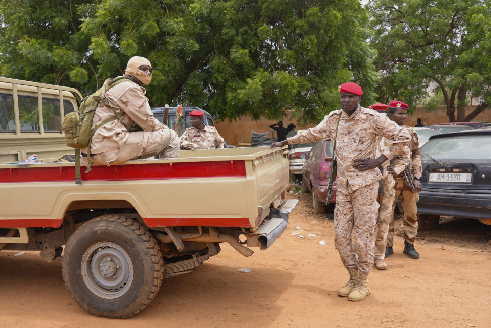 Nigerien national guardsmen sit outside the customs offices in Niamey, Niger, Monday, Aug. 21, 2023. Around 300 trucks of food and other materials crossed into Niger from Burkina Faso with many arriving in the capital, Niamey Sunday, according to a regional custom's official. (AP Photo/Sam Mednick)