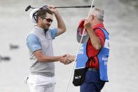 Andrew Landry, left, celebrates with his caddie Terry Walker after winning The American Express golf tournament on the Stadium Course at PGA West in La Quinta, Calif., Sunday, Jan. 19, 2020. (AP Photo/Alex Gallardo)