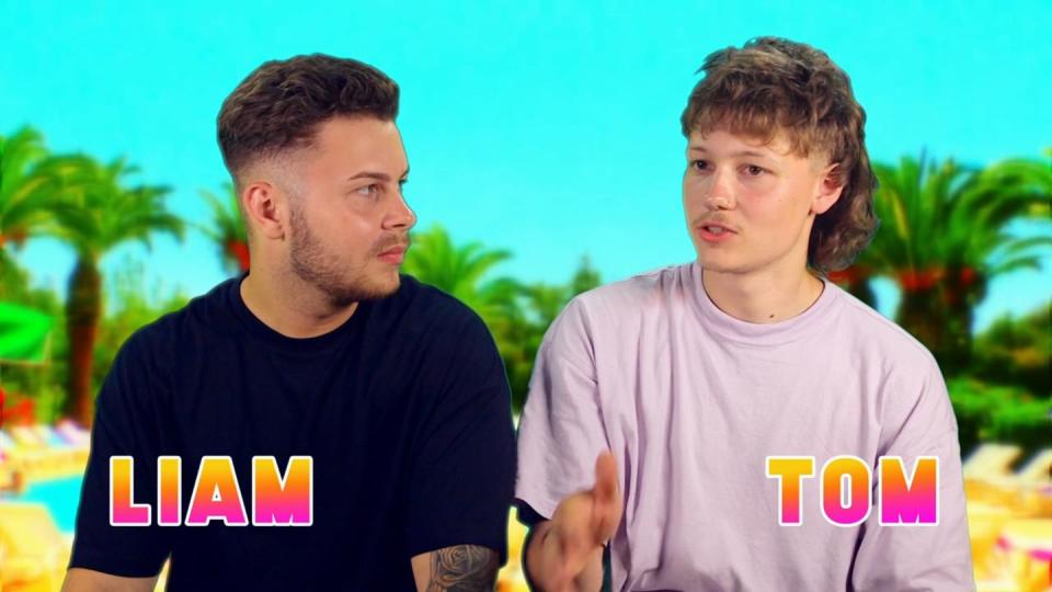 big brother 2023 tom with his friend liam on kavos weekender, wearing plain t shirts in a confessional against an out of focus tropical backdrop