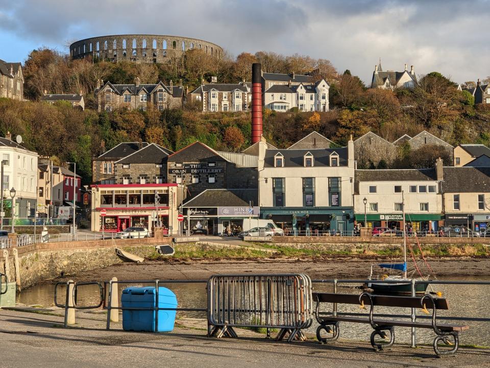 View of Oban from train window, buildings perched on a hill