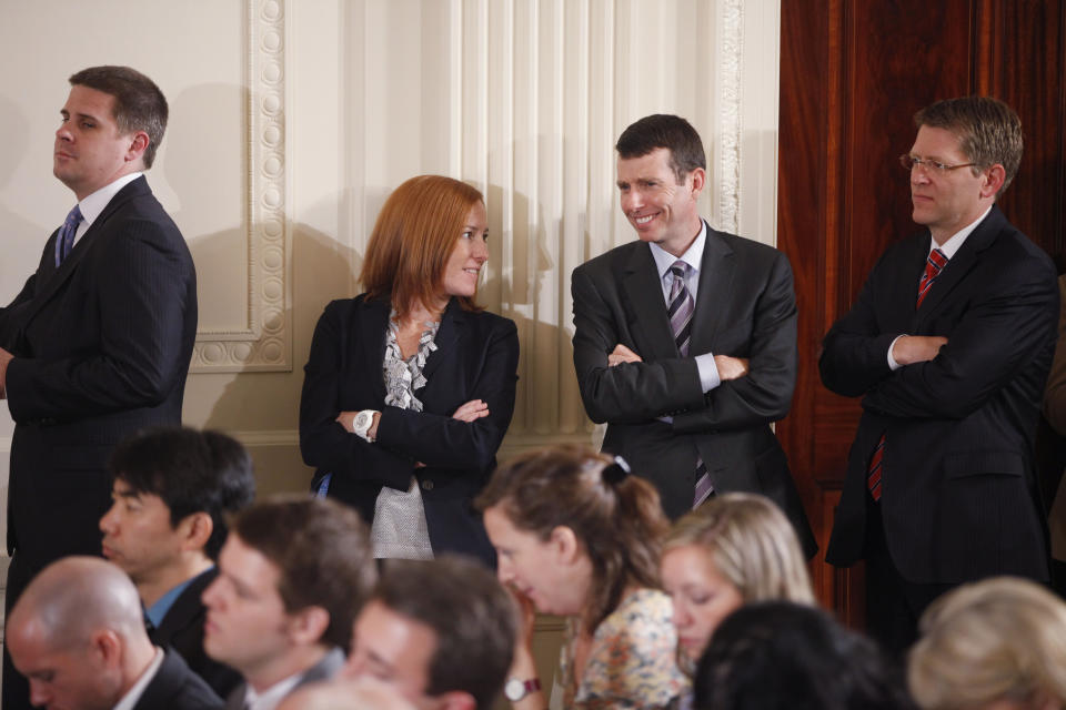 FILE - In this June 29, 2011 file photo, from left, White House Communications Director Dan Pfeiffer; Deputy Communications Director Jen Psaki; Senior Adviser David Plouffe; and Press Secretary Jay Carney stand in the East Room as President Barack Obama holds a news conference at the White House in Washington. (AP Photo/Charles Dharapak, File)