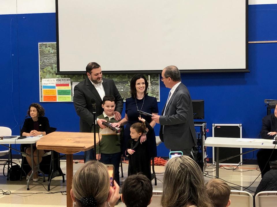 Lauren Spirig, center, takes the oath of office for the Mendham Township Committee accompanied by her husband, John; son Luke, 7; and daughter Zoey, 5, during the committee's reorganization at Mendham Township Middle School Thursday, Jan. 5, 2023. Administering the oath is Mendham attorney Tom Murphy.