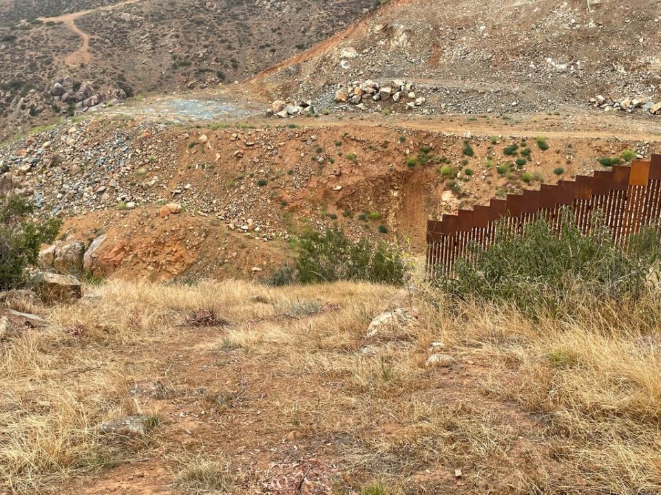 Border wall construction in the Otay Mountain wilderness involved heavy machinery and blasting dynamite. The fencing has been left with a large gap (The Independent)