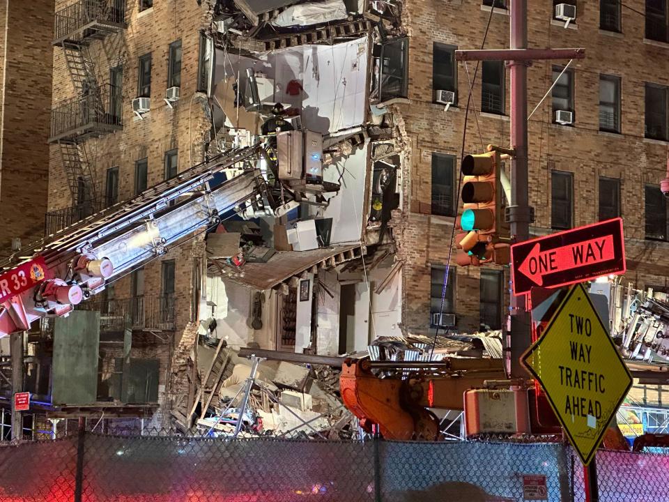 Firefighters continue to work the scene at a six-story corner of a Bronx apartment building that collapsed Monday, Dec. 11, 2023, in New York. There were no reports of injuries by early evening, but firefighters were continuing to search.