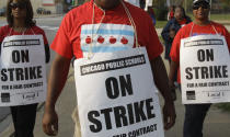 Smaller, more subdued groups of teachers picket outside Morgan Park High School in Chicago, Monday, Sept. 17, 2012, as a strike by Chicago Teachers Union members heads into its second week. Mayor Rahm Emanuel said he will seek a court order to force the city's teachers back into the classroom. (AP Photo/M. Spencer Green)