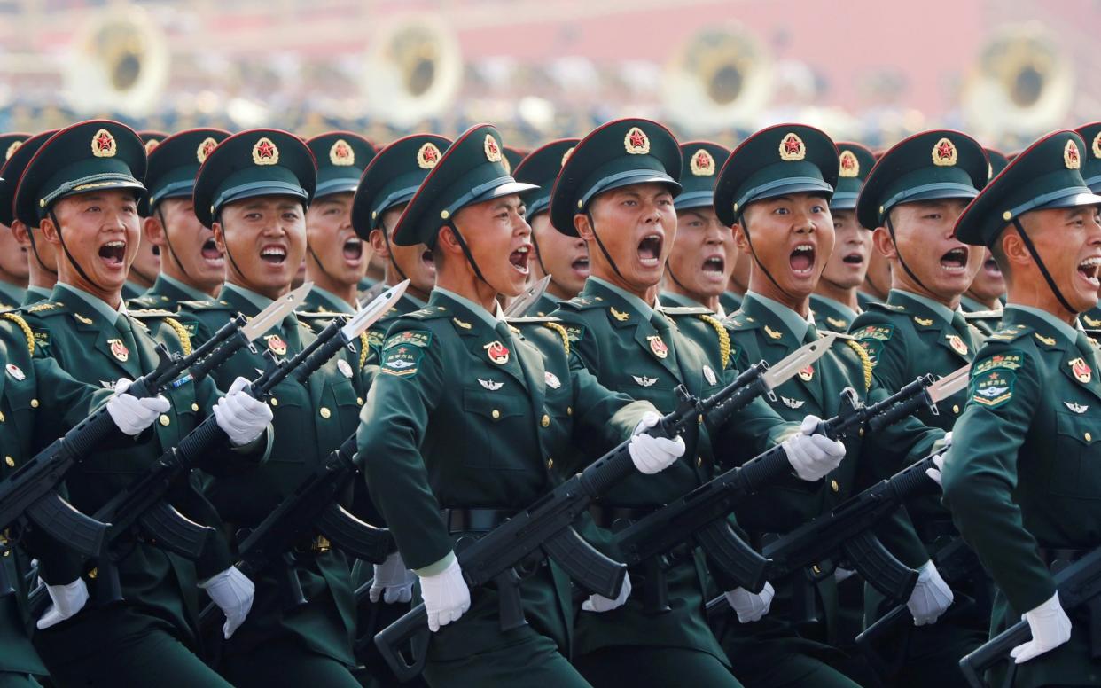 People's Liberation Army (PLA) soldiers march in formation during the military parade marking the 70th founding anniversary of People's Republic of China in 2019 - THOMAS PETER /REUTERS
