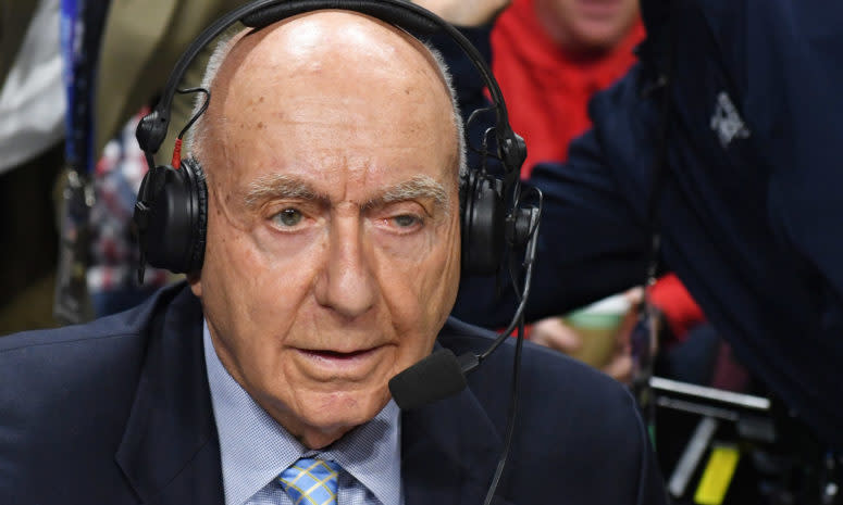 A closeup of Dick Vitale wearing a headset.