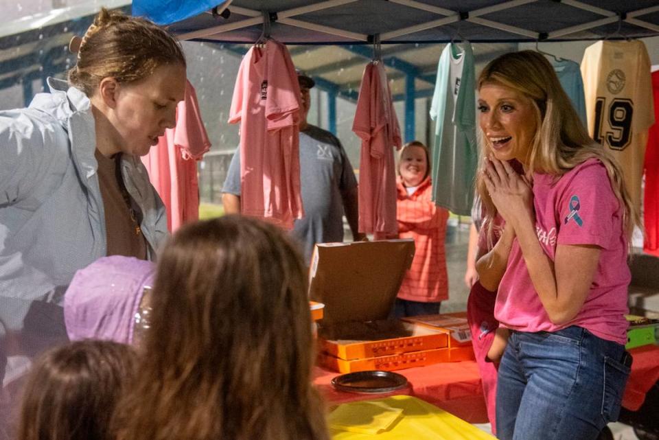 Heather Wyatt works a concession stand selling pizza and T-shirts at the opening ceremony for the Ocean Springs Girls Softball League at the Ocean Springs Sports Complex on March 4. During the ceremony, Wyatt gave a speech to the young girls, in honor of her daughter Aubreigh, about suicide prevention and bullying.