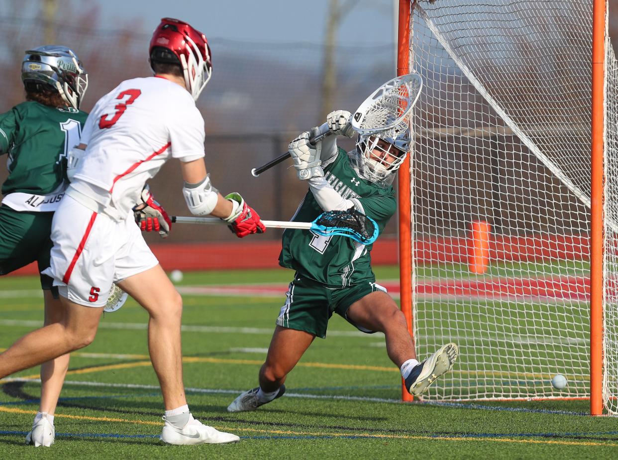 Somers' Mac Sullivan (3) gets a shot past Pleasantville goalie Andrew Nessel (4) for a first half goal during boys lacrosse action at  Somers High School April 4, 2023. Pleasantville won the game 13-5.
