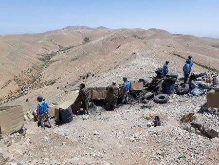 Fighters from the Syrian army units and Hezbollah are seen on the western mountains of Qalamoun, near Damascus, in this handout picture provided by SANA on July 23, 2017, Syria. SANA/Handout via REUTERS