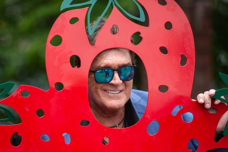 Country singer-songwriter and Humboldt native T.G. Sheppard poses through a strawberry-cutout during the West Tennessee Strawberry Festival in Humboldt, Tenn. on Friday, May 12, 2023.