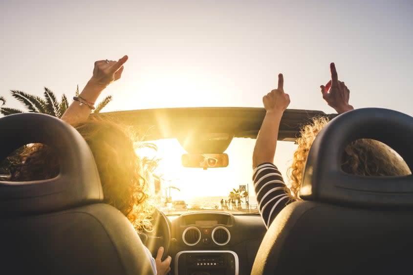 Women riding in a convertible.