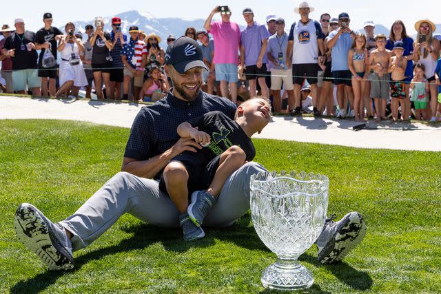 <p>Isaiah Vazquez/Getty </p> Steph Curry and son Canon