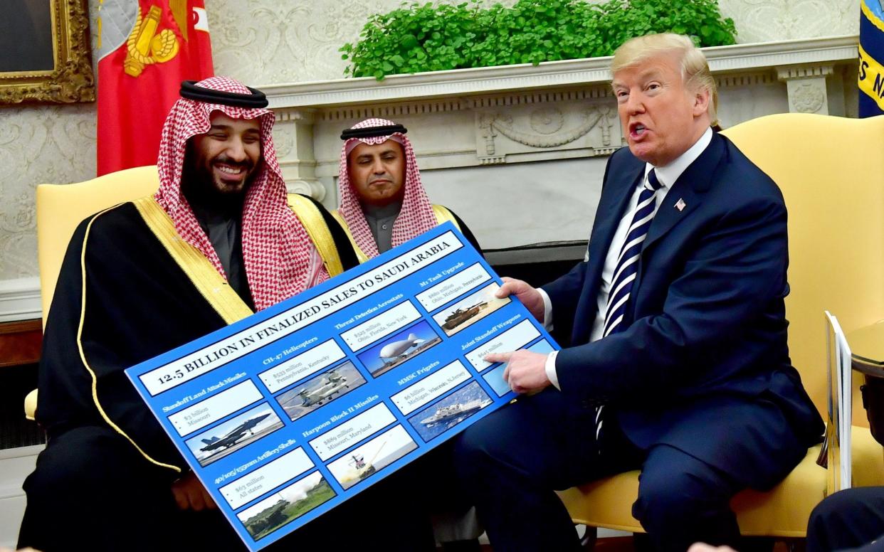 President Donald Trump (R) holds up a chart of military hardware sales as he meets with Crown Prince Mohammed bin Salman of the Kingdom of Saudi Arabia in the Oval Office at the White House - Barcroft Media
