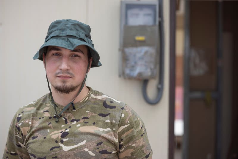 Oleksauk, a soldier who returned from Sievierodonetsk, poses for a picture with his friend in Slovyansk