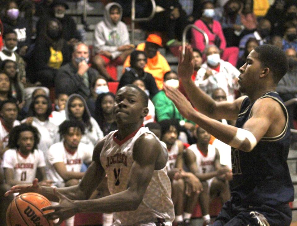 Jackson guard Joseph Bargeron (10) goes up for a shot as Paxon forward Saryn Hatcher (21) defends during  the Gateway Conference high school boys basketball final on January 28, 2022. [Clayton Freeman/Florida Times-Union]